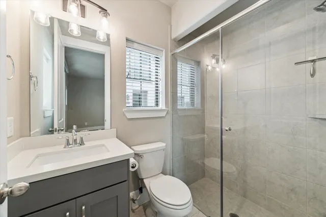 a bathroom with a sink toilet and shower