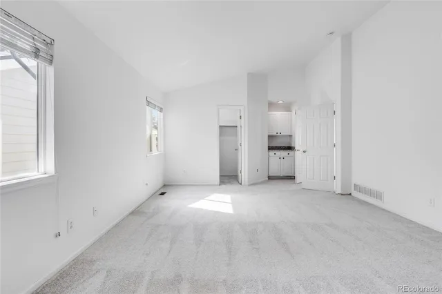 an empty room with windows and natural light