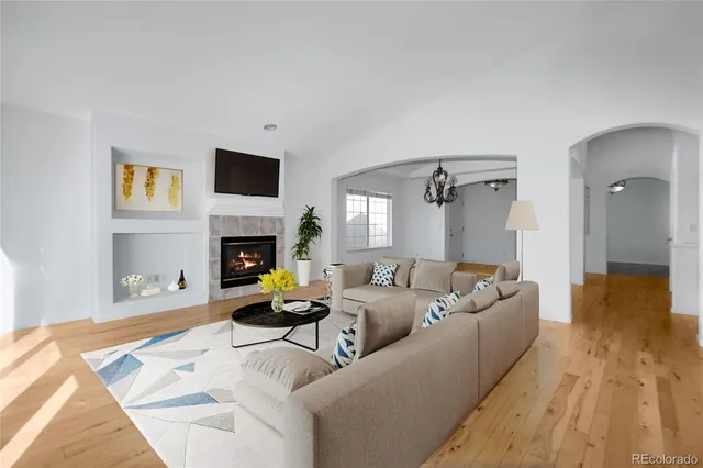 a living room with furniture and a fireplace