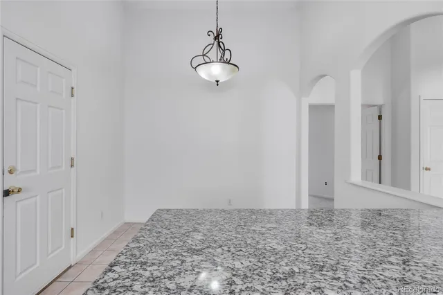 a view of a room with wooden floor and white walls