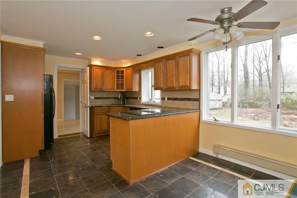 31 Parker Road Edison, NJ 08820 - Photo 8 of 25 a kitchen with stainless steel appliances granite countertop a refrigerator a sink a stove a washer and a window