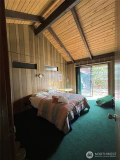 a bed sitting in a bedroom next to a window