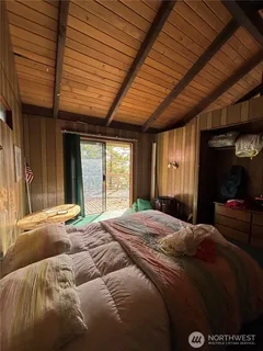 a bedroom with a bed and a large window