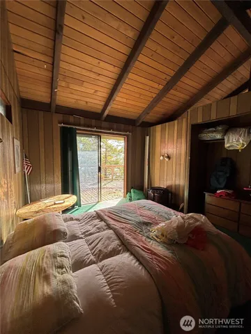 a bedroom with a bed and a large window