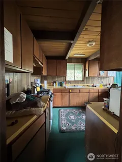 a kitchen with table and chairs