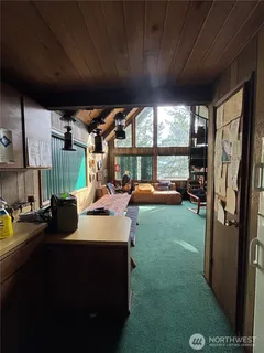 a view of a porch with furniture and a garden