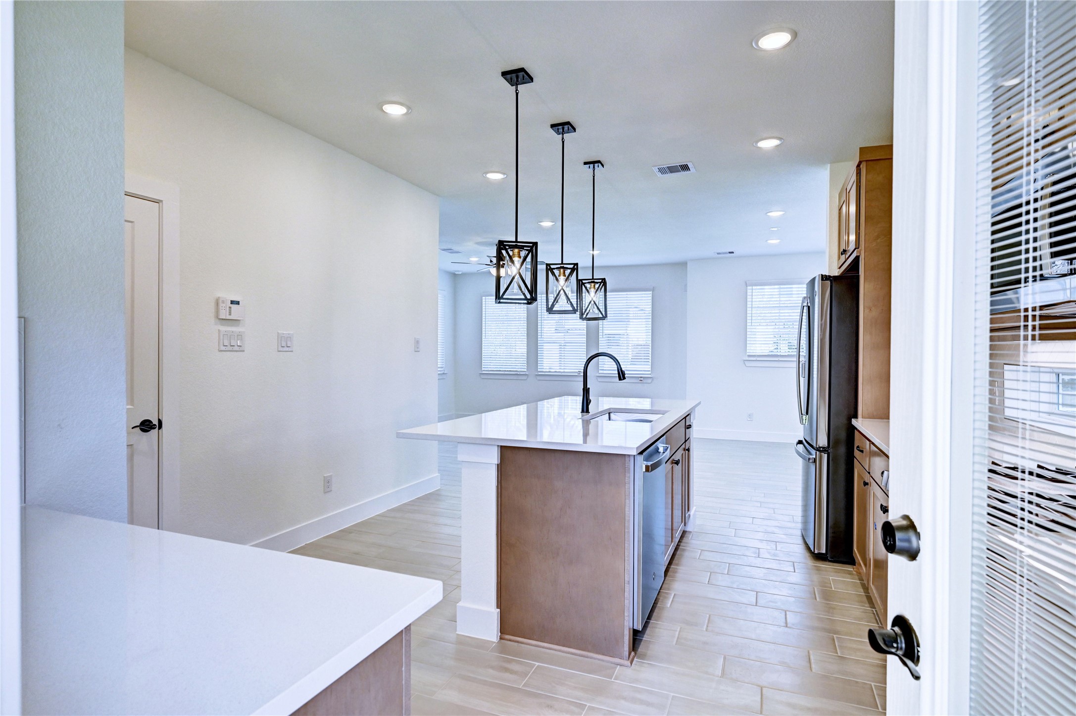 7643 Meadow Mouse Lane Katy, TX 77493 - Photo 11 of 35 a kitchen with stainless steel appliances a sink and a refrigerator