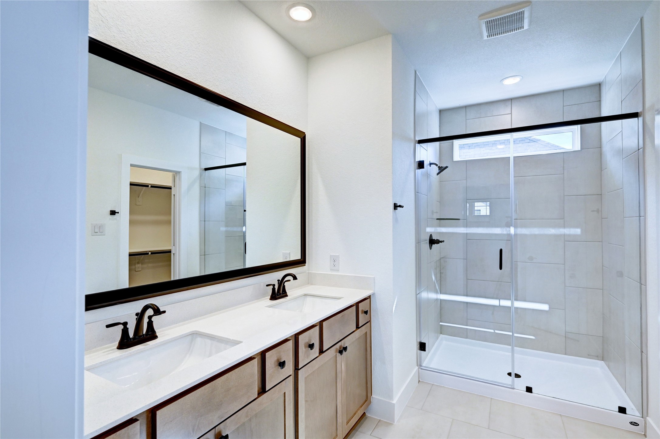 7643 Meadow Mouse Lane Katy, TX 77493 - Photo 19 of 35 a bathroom with a double vanity sink mirror double and bathtub