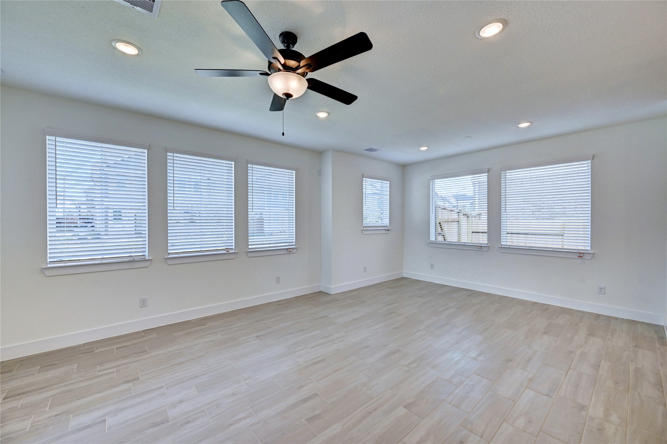 7643 Meadow Mouse Lane Katy, TX 77493 - Photo 5 of 35 a view of an empty room with a window and wooden floor