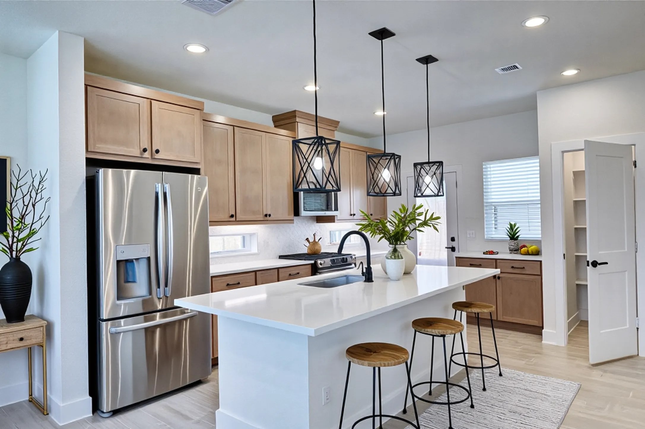 7643 Meadow Mouse Lane Katy, TX 77493 - Photo 7 of 35 a kitchen with refrigerator a sink and chairs