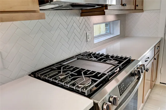 a close up of a stove top oven sitting inside of a kitchen