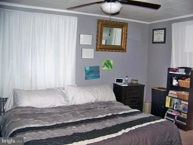 a bedroom with a bed and a bookshelf