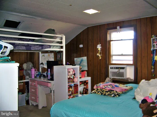 a bedroom with furniture and a window