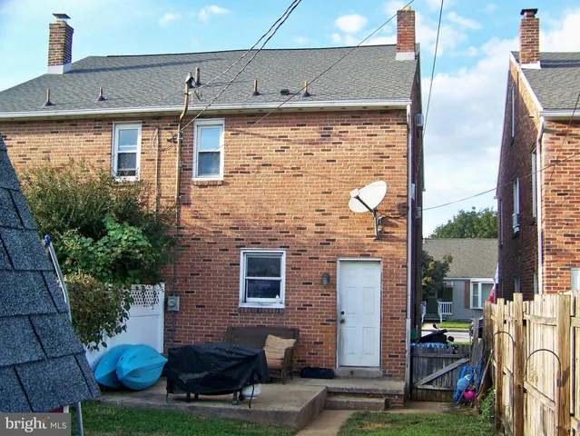 a backyard of a house with yard and trampoline