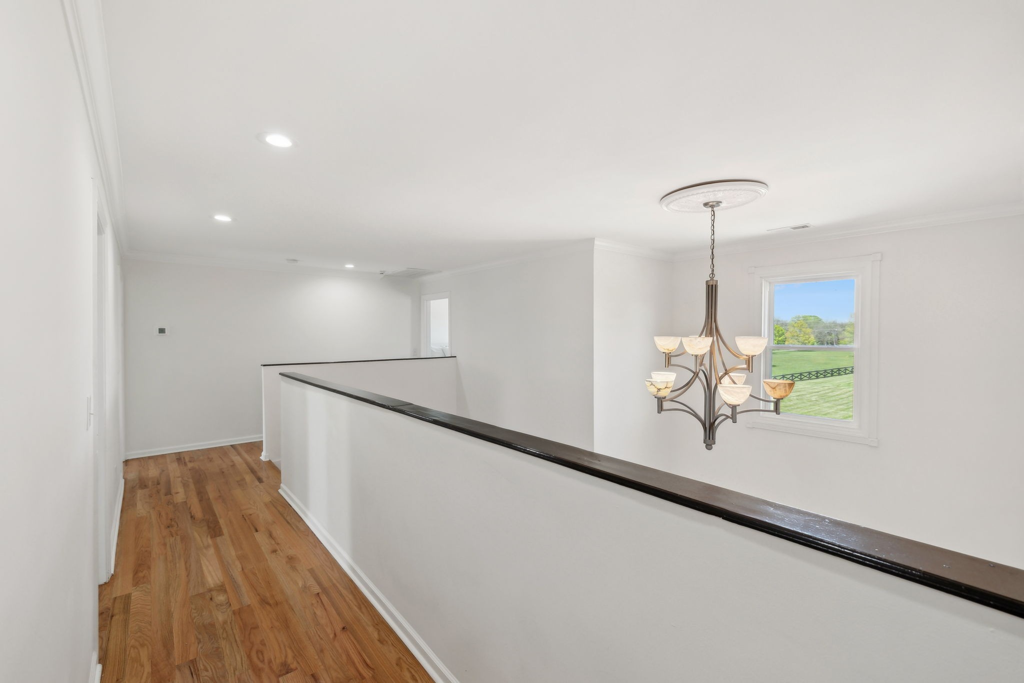 422 Davis Road Lebanon, TN 37087 - Photo 62 of 87 a view of a hallway with wooden floor and chandelier