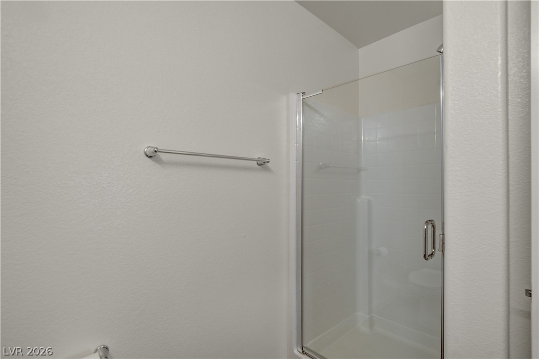 6924 Spicy Merlot Street North Las Vegas, NV 89086 - Photo 28 of 83 A well-appointed shower stall features a sleek glass enclosure and clean white tiling.