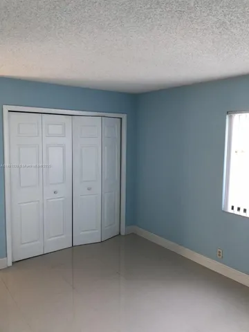 a view of an empty room and a window