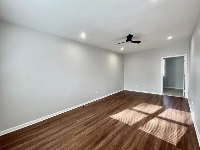 a view of an empty room and wooden floor