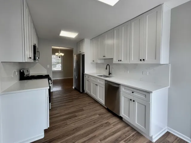 a kitchen with stainless steel appliances sink a microwave and cabinets
