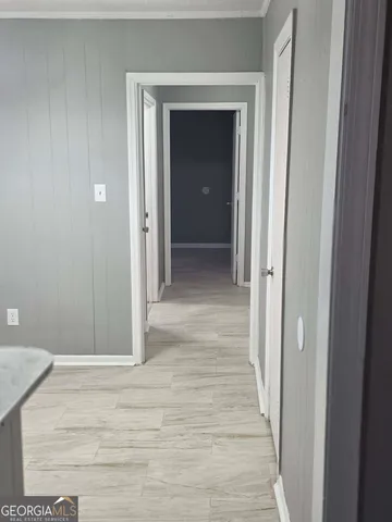 a view of a hallway with wooden floor