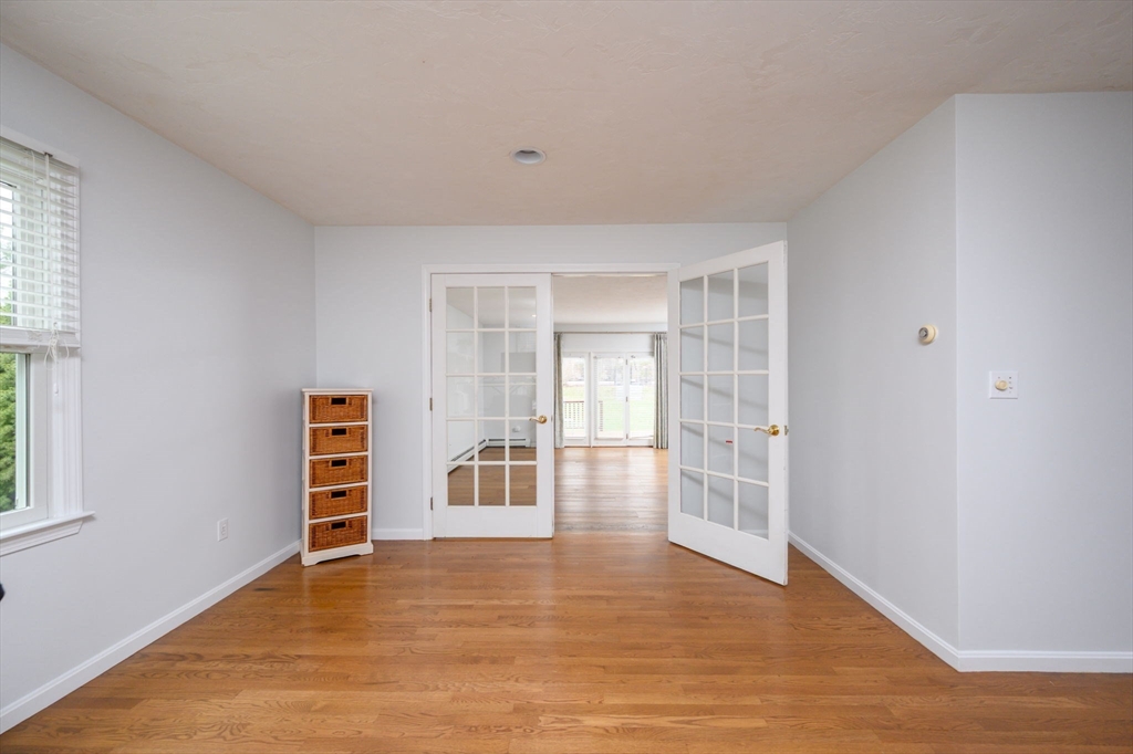 72 Pilgrim Trail Marshfield, MA 02050 - Photo 15 of 42 an empty room with wooden floor and windows