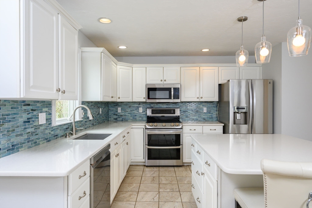 72 Pilgrim Trail Marshfield, MA 02050 - Photo 7 of 42 a kitchen with a sink stainless steel appliances and white cabinets