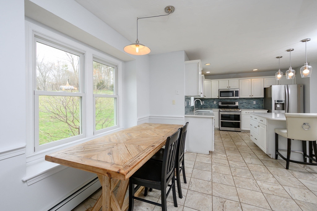72 Pilgrim Trail Marshfield, MA 02050 - Photo 8 of 42 a kitchen with kitchen island a large counter top space appliances and cabinets