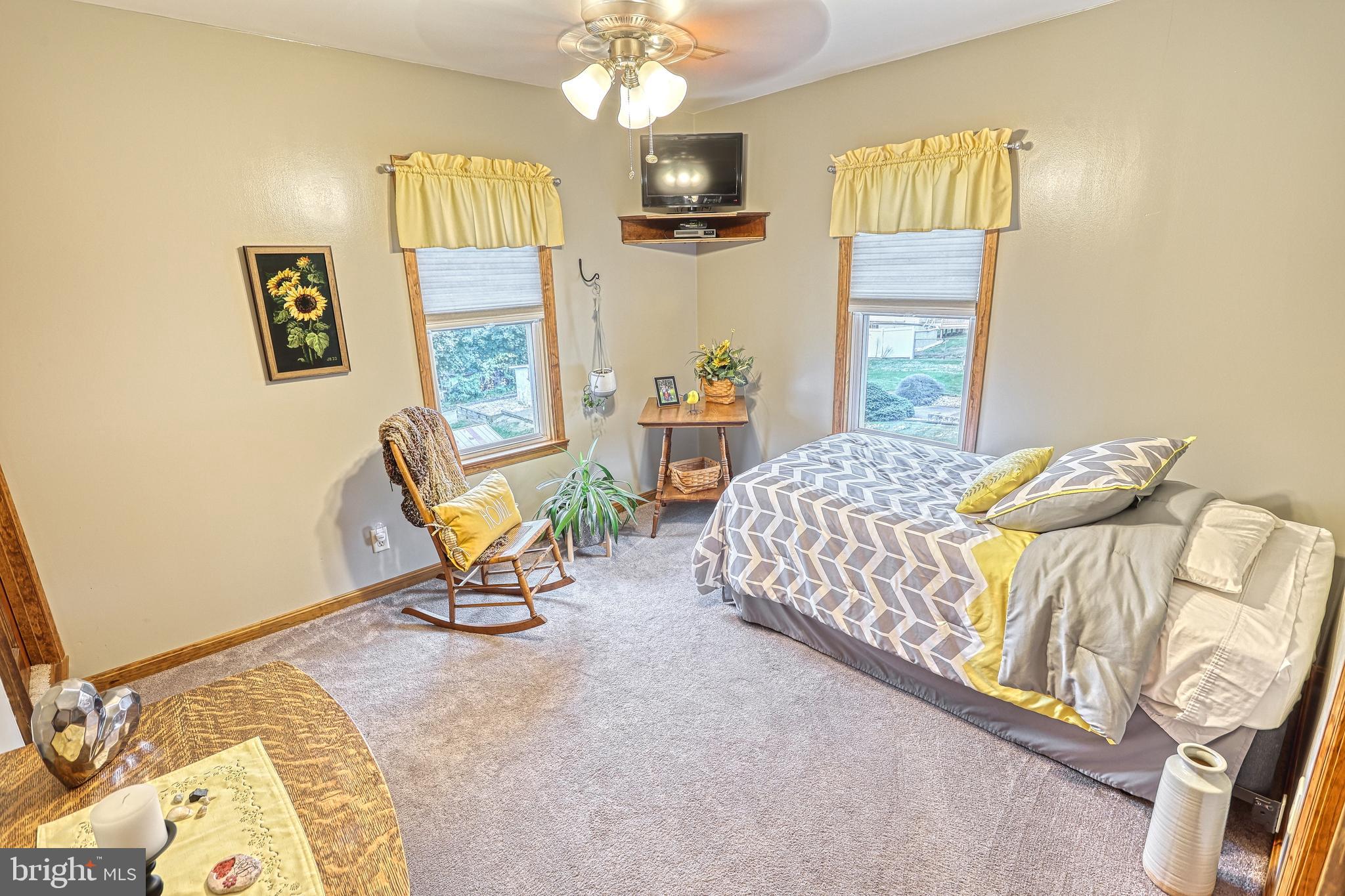3 West High Street Windsor, PA 17366 - Photo 34 of 63 a bedroom with a bed a chandelier and a dresser