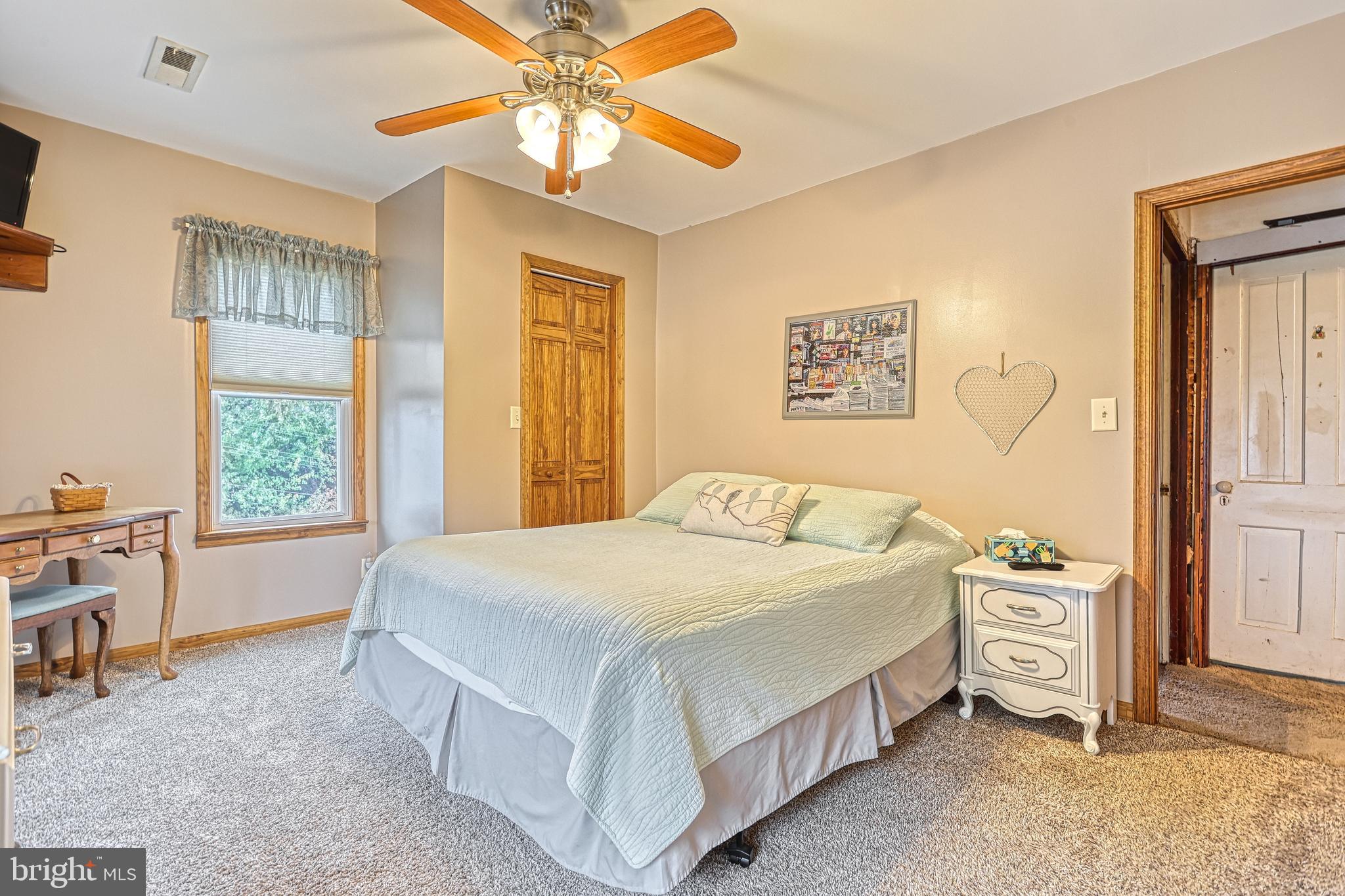 3 West High Street Windsor, PA 17366 - Photo 35 of 63 a bedroom with a bed and a chandelier