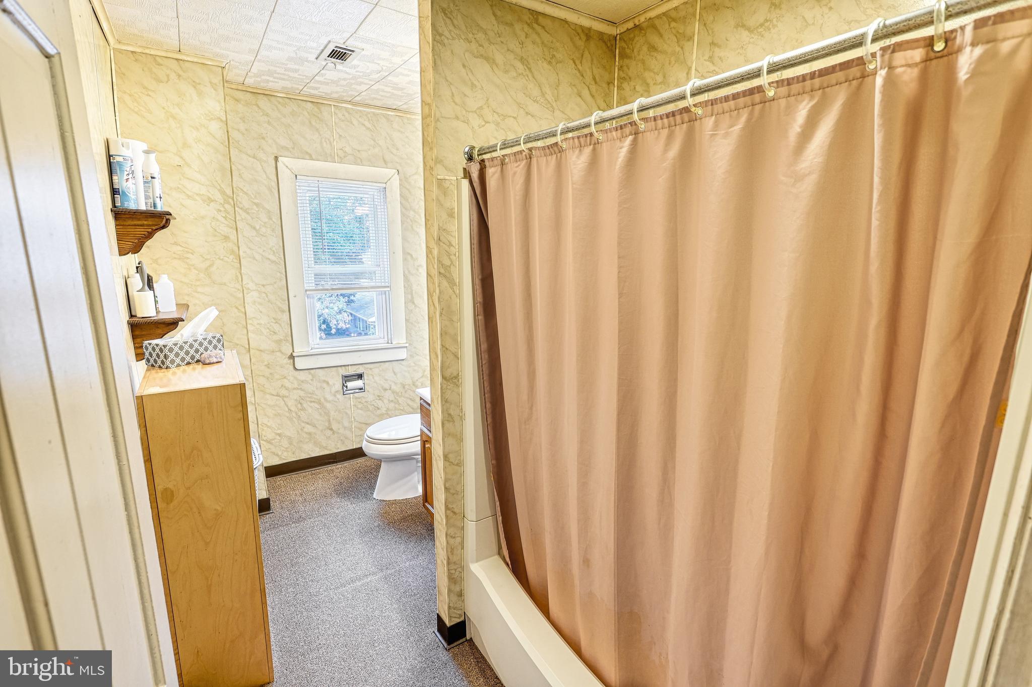 3 West High Street Windsor, PA 17366 - Photo 36 of 63 a view of a bathroom with a shower curtain