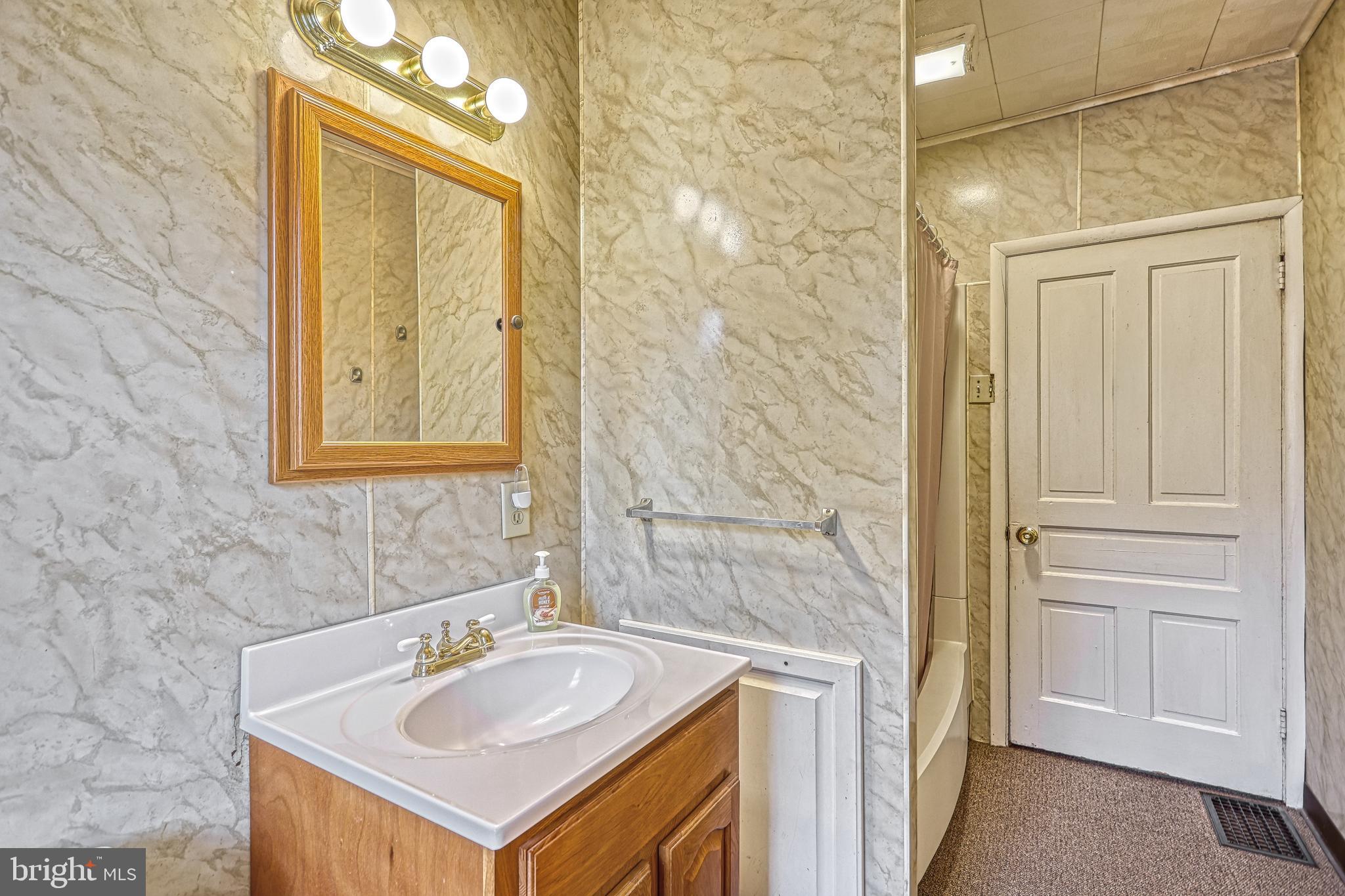 3 West High Street Windsor, PA 17366 - Photo 37 of 63 a bathroom with a sink vanity and a mirror