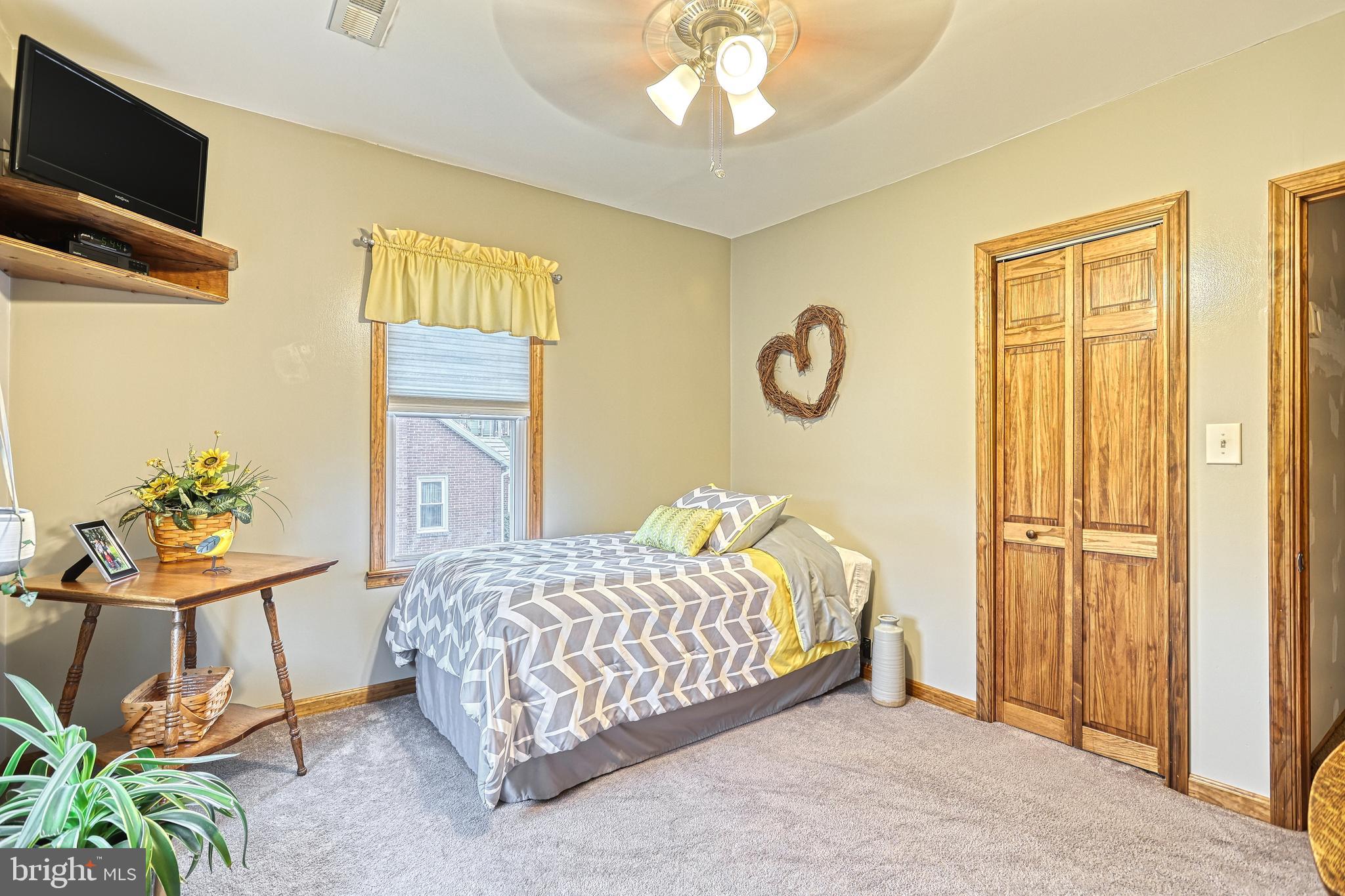 3 West High Street Windsor, PA 17366 - Photo 40 of 63 a bedroom with a bed and a chandelier