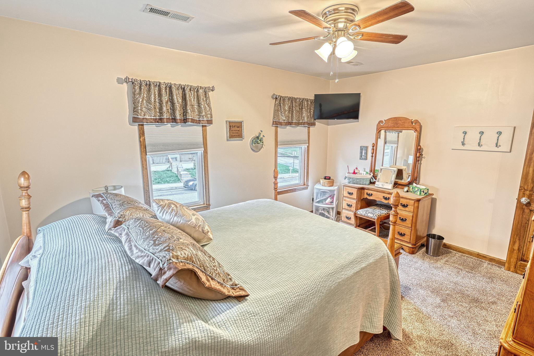 3 West High Street Windsor, PA 17366 - Photo 41 of 63 a bedroom with a bed and a chandelier