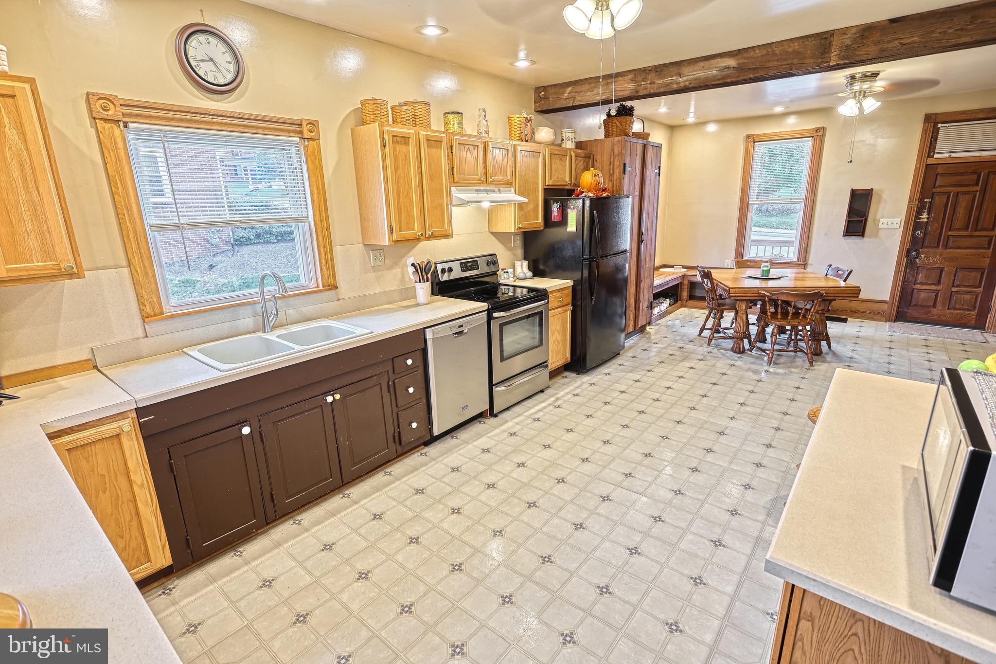 3 West High Street Windsor, PA 17366 - Photo 46 of 63 a large kitchen with a sink and dishwasher a refrigerator with wooden floor