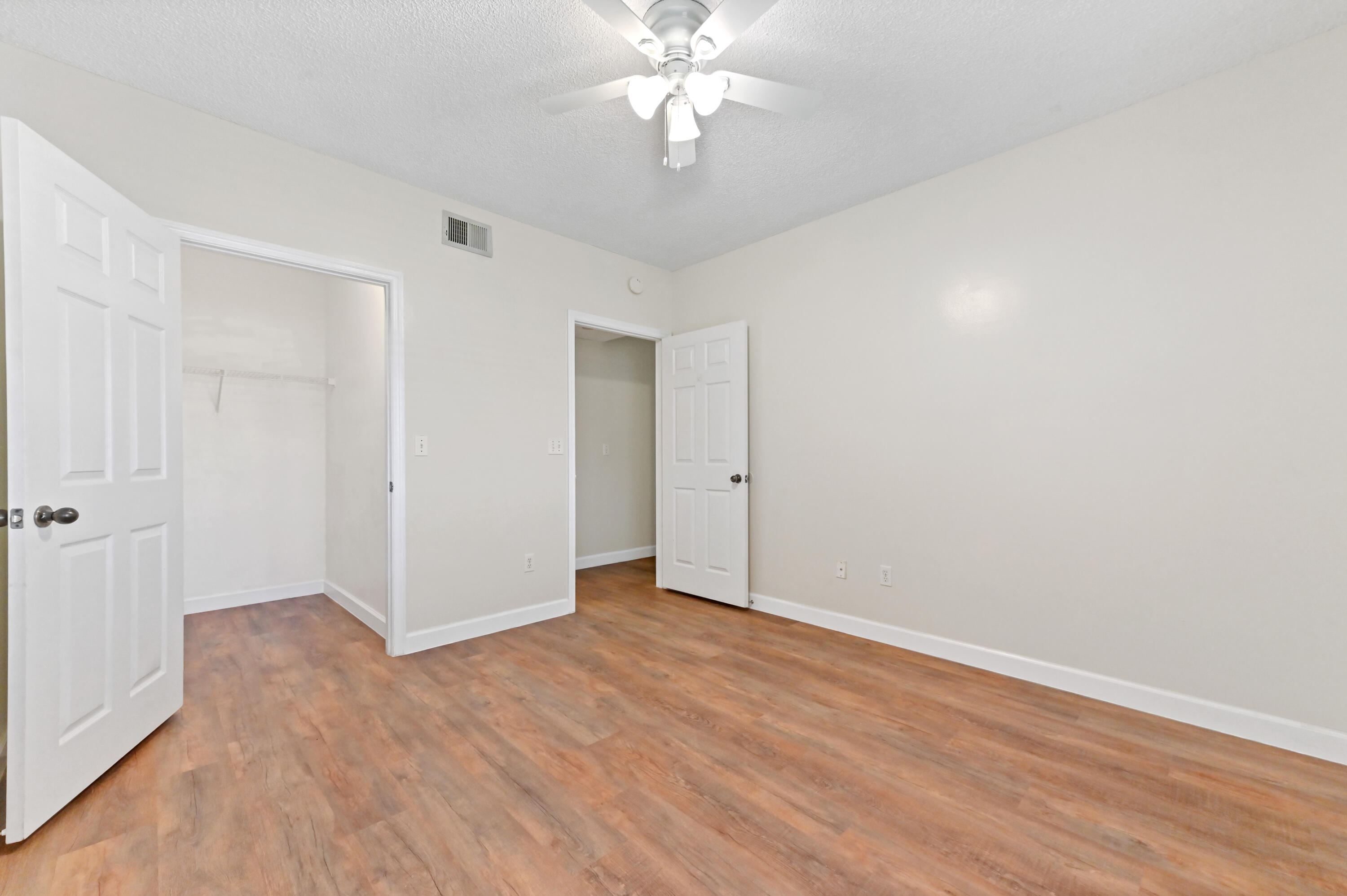 10306 Fox Trail Road South, Unit 906 West Palm Beach, FL 33411 - Photo 13 of 26 a view of an empty room with wooden floor