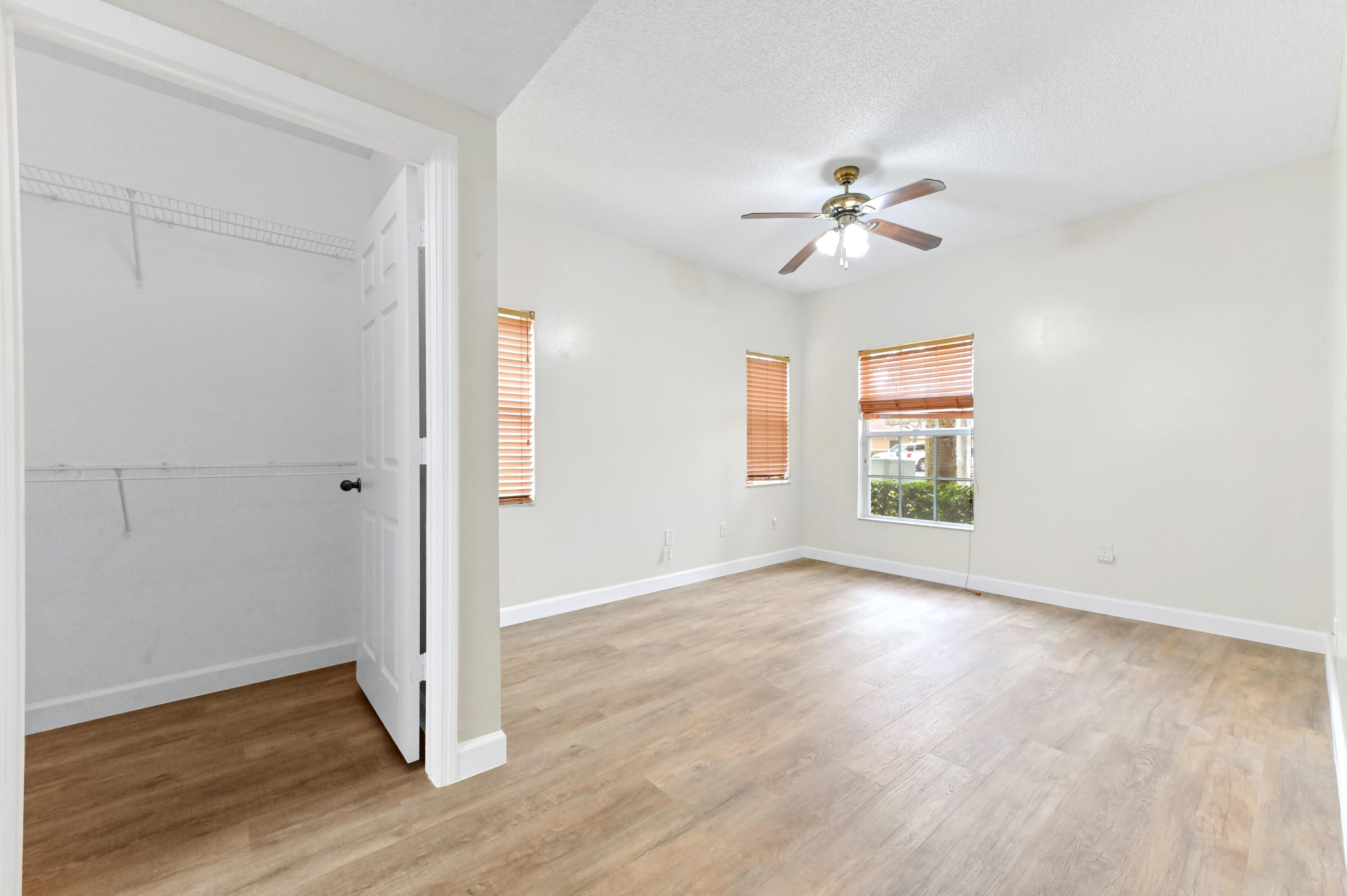 10306 Fox Trail Road South, Unit 906 West Palm Beach, FL 33411 - Photo 15 of 26 wooden floor in an empty room with a window