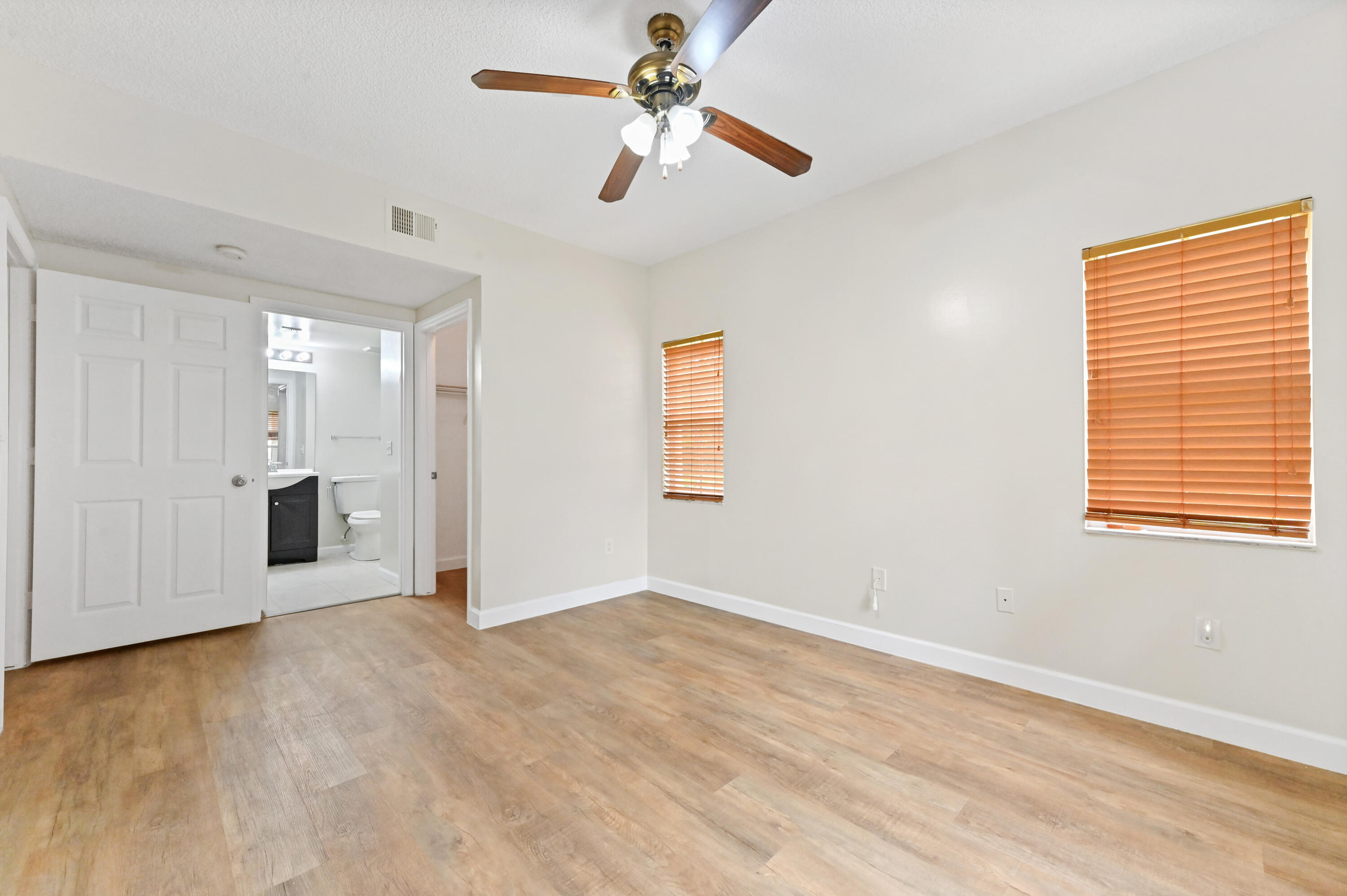 10306 Fox Trail Road South, Unit 906 West Palm Beach, FL 33411 - Photo 17 of 26 a view of a room with a ceiling fan and a window
