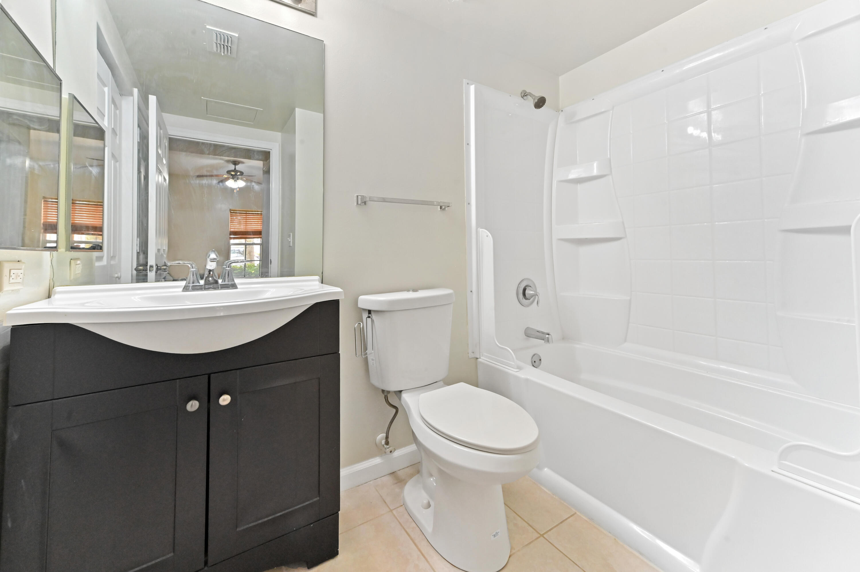 10306 Fox Trail Road South, Unit 906 West Palm Beach, FL 33411 - Photo 19 of 26 a bathroom with a sink a toilet and shower