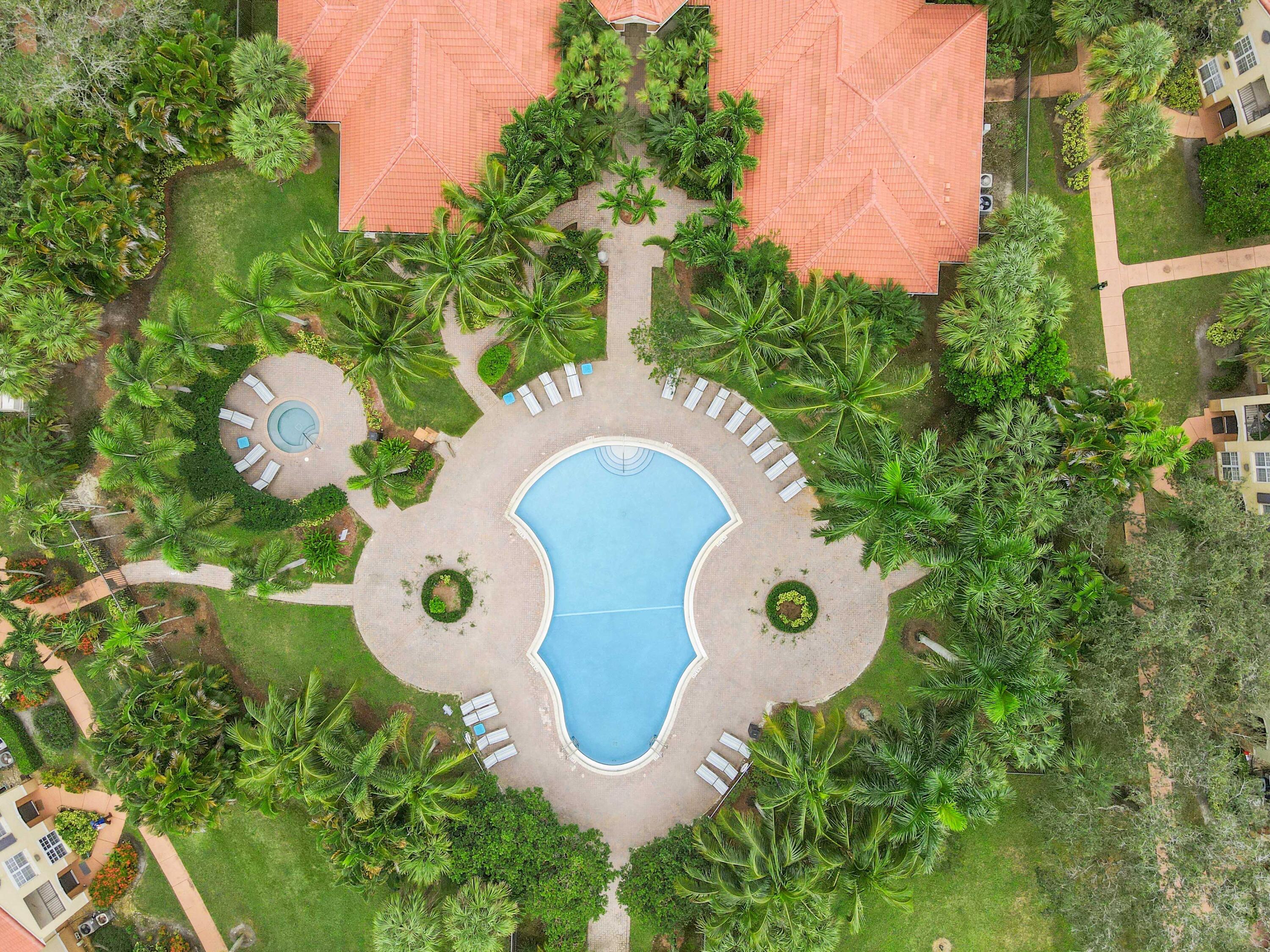 10306 Fox Trail Road South, Unit 906 West Palm Beach, FL 33411 - Photo 21 of 26 a aerial view of a house with garden space and outdoor seating