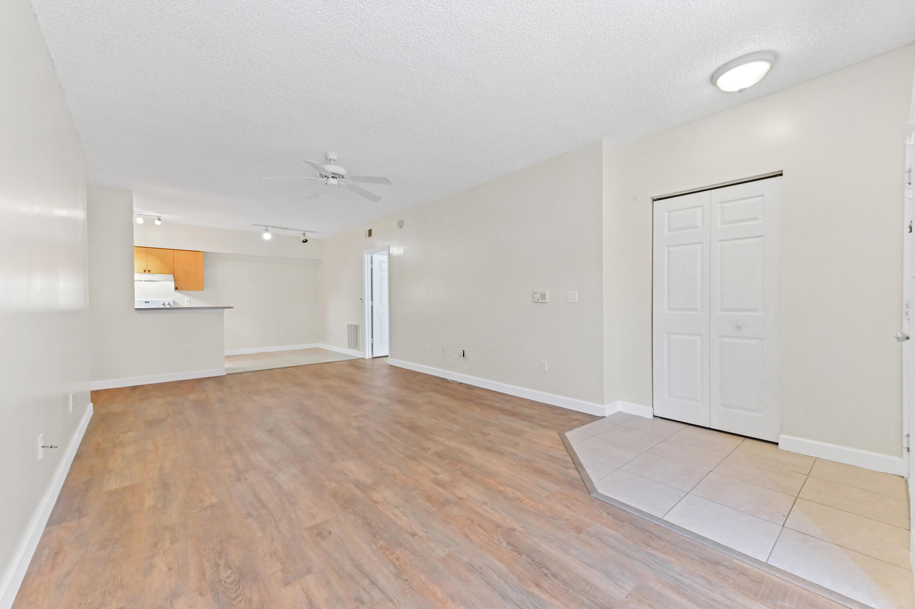 10306 Fox Trail Road South, Unit 906 West Palm Beach, FL 33411 - Photo 5 of 26 an empty room with wooden floor and windows