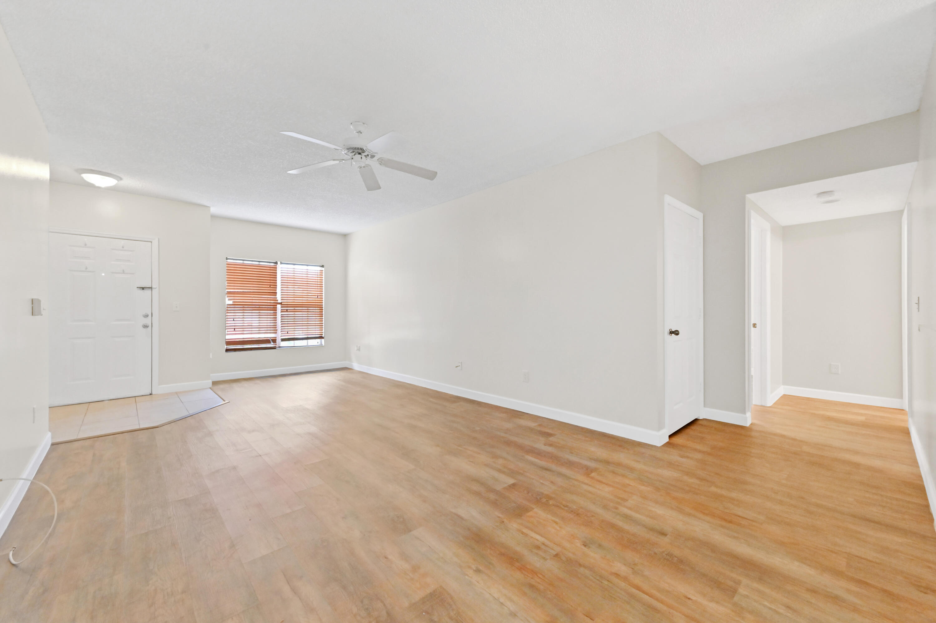 10306 Fox Trail Road South, Unit 906 West Palm Beach, FL 33411 - Photo 6 of 26 wooden floor in an empty room