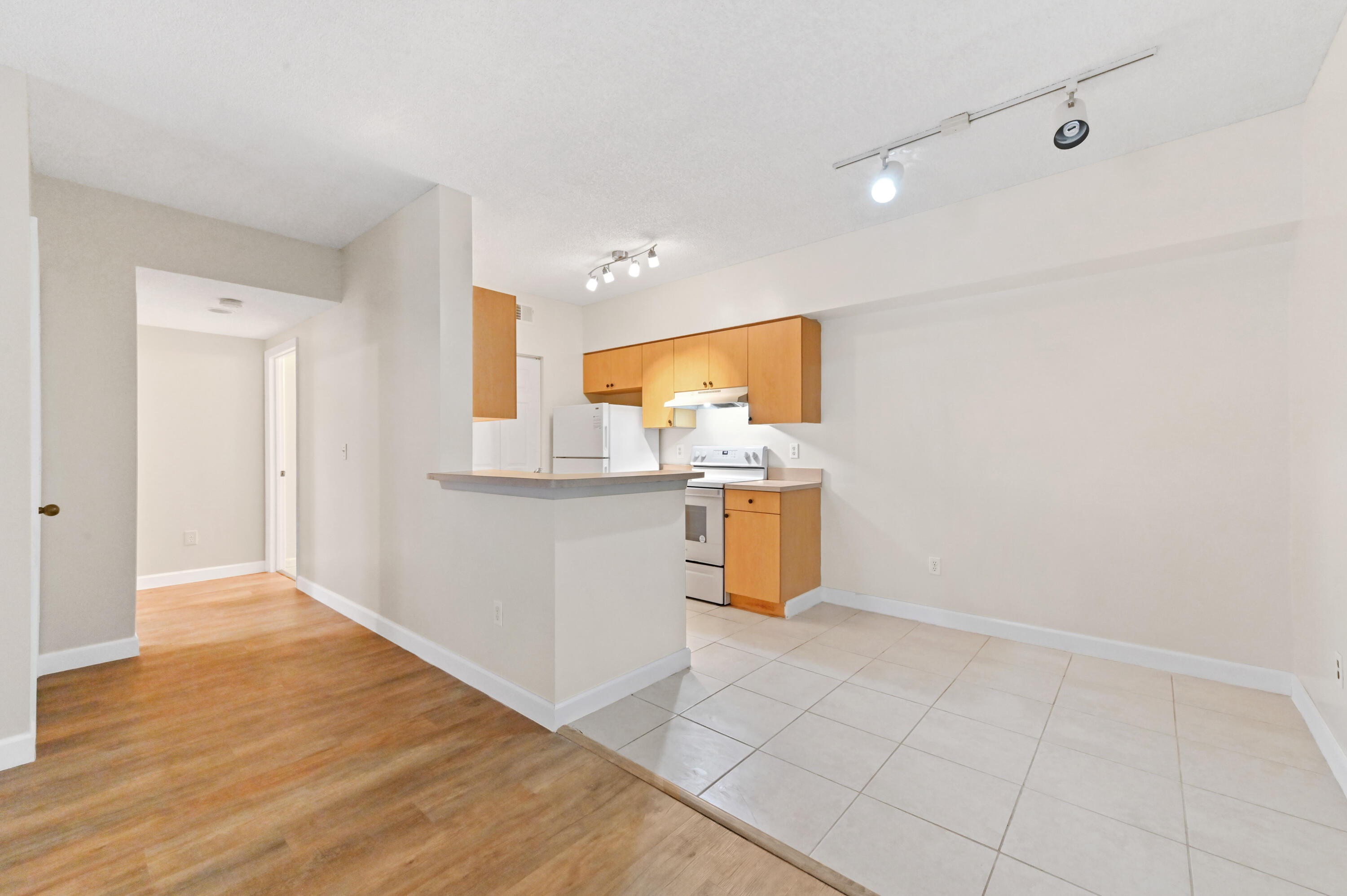 10306 Fox Trail Road South, Unit 906 West Palm Beach, FL 33411 - Photo 7 of 26 a view of a kitchen with a sink and a microwave