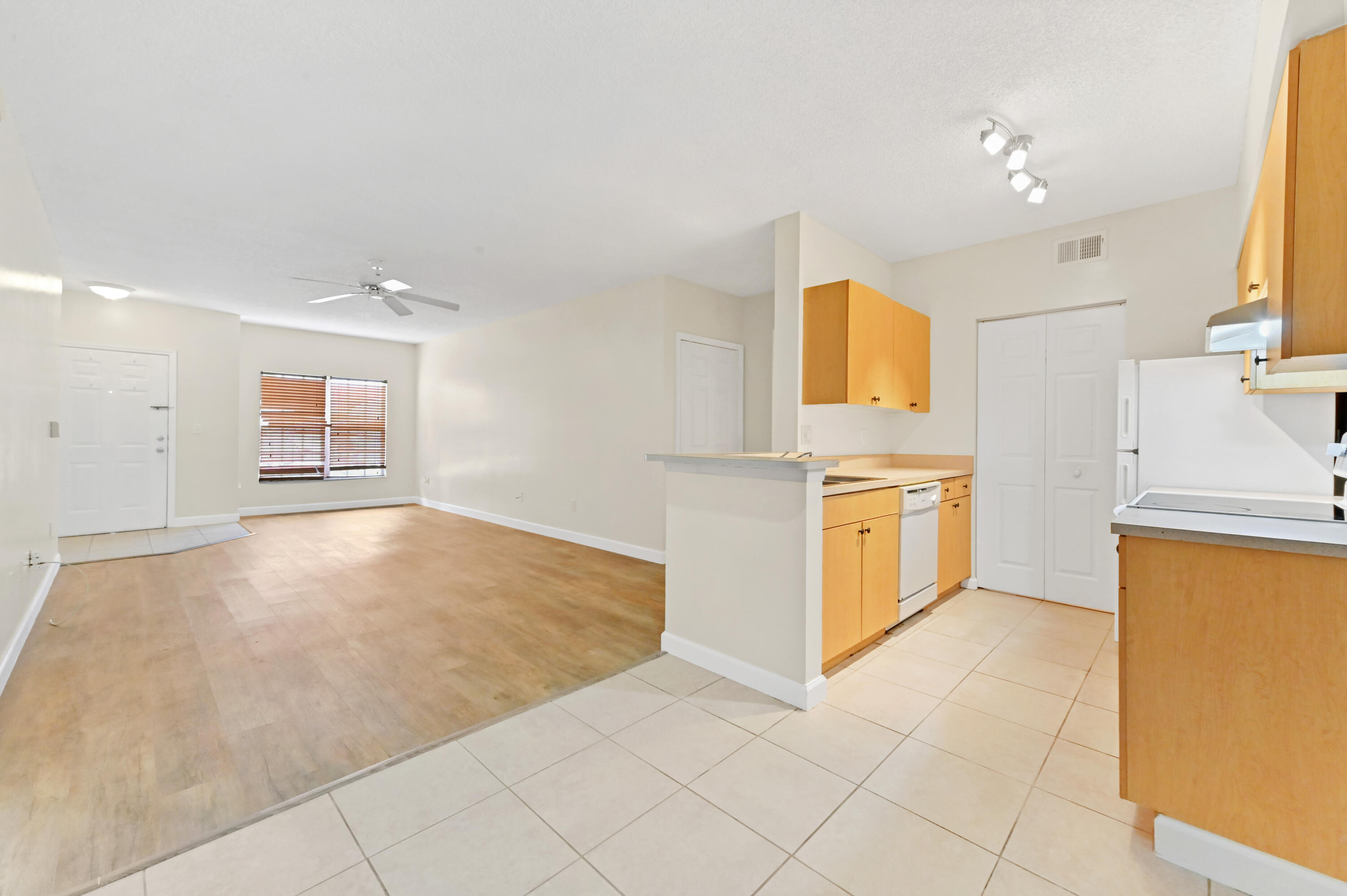 10306 Fox Trail Road South, Unit 906 West Palm Beach, FL 33411 - Photo 8 of 26 a view of a kitchen with refrigerator and microwave