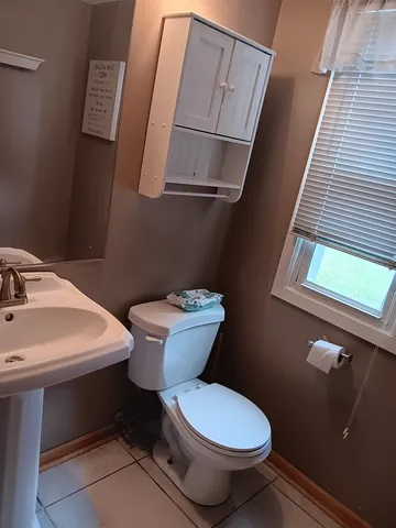 a white toilet sitting next to a bathroom sink