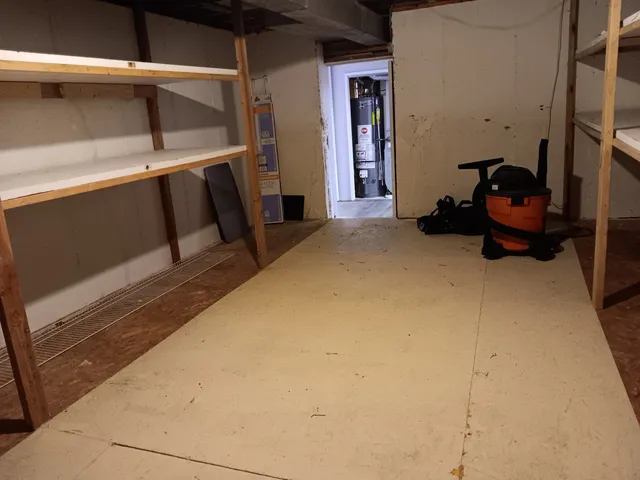 a view of a house with a yard and large tree