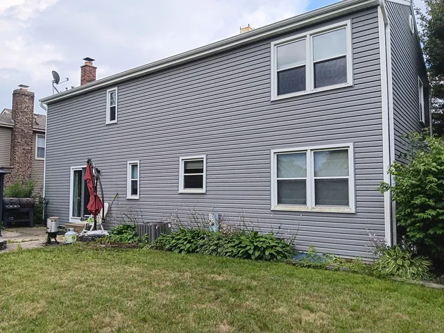 a group of people sitting in front of a house