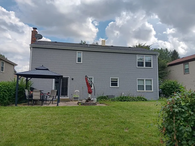 a view of a house with a backyard