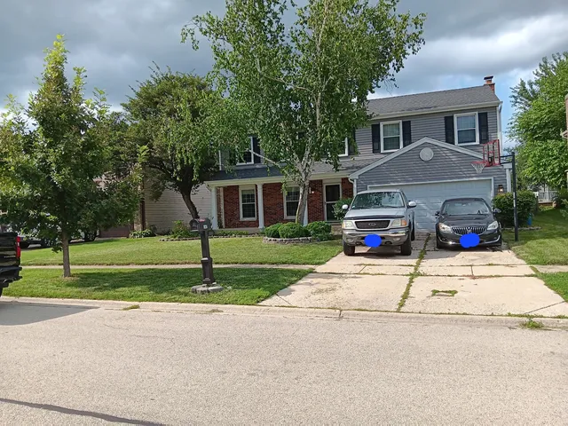 a front view of house with yard and green space