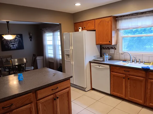 a kitchen with stainless steel appliances a sink cabinets and refrigerator