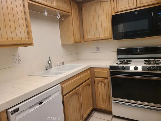 a kitchen with wooden cabinets and a stove top oven